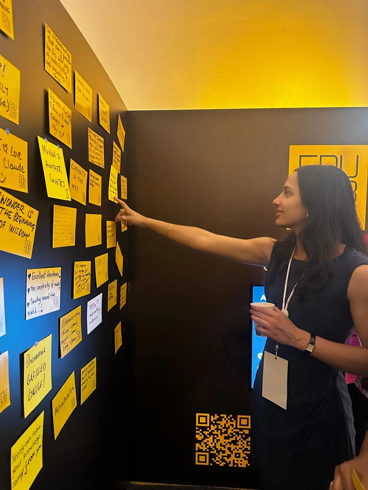 Woman interacting with sticky note wall